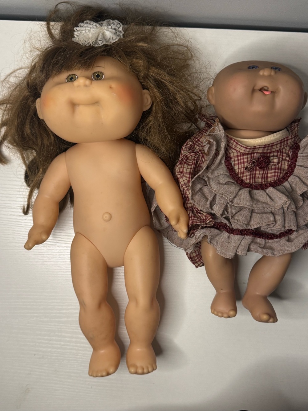 Brown-Haired Vinyl Baby Doll with Playful Face